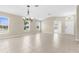 Bright living area with tile floors, multiple windows, and elegant chandeliers at 5255 Layton Dr, Venice, FL 34293