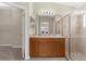 Bathroom featuring double sinks, vanity storage, and glass enclosed shower at 5255 Layton Dr, Venice, FL 34293