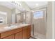 Bright bathroom features double sinks, ample storage, and glass enclosed shower at 5255 Layton Dr, Venice, FL 34293