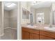 En-suite bathroom with dual sinks, a large mirror, and walk-in closet access at 5255 Layton Dr, Venice, FL 34293