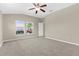 Carpeted main bedroom with windows providing views to the landscaped yard at 5255 Layton Dr, Venice, FL 34293