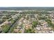 An aerial view of a residential neighborhood with tree-lined streets, waterways, and a mix of single-Gathering homes at 5417 Maccaughey Dr, North Port, FL 34287
