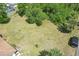 Aerial view of backyard featuring lush greenery, mature trees, and outdoor living at 5417 Maccaughey Dr, North Port, FL 34287