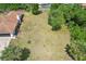 Aerial view of the home's expansive backyard, lush greenery, mature trees and outdoor living at 5417 Maccaughey Dr, North Port, FL 34287