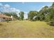 Expansive backyard view showing plentiful green space under a clear sky at 5417 Maccaughey Dr, North Port, FL 34287