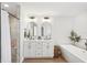Stylish bathroom featuring double sinks, sleek fixtures, a glass-enclosed shower, and a modern soaking tub at 5417 Maccaughey Dr, North Port, FL 34287