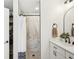Neutral bathroom featuring a marble tiled shower with glass door, modern vanity and hardware, and storage at 5417 Maccaughey Dr, North Port, FL 34287