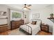 Comfortable bedroom with a ceiling fan, natural light, and neutral decor at 5417 Maccaughey Dr, North Port, FL 34287