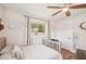 Bedroom features a ceiling fan, two windows, wood floors, and soft decor touches, creating a soothing atmosphere at 5417 Maccaughey Dr, North Port, FL 34287