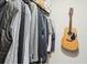 Organized closet with clothing on hangers and a guitar on the wall adds charm and functionality at 5417 Maccaughey Dr, North Port, FL 34287