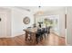 Bright dining room features a large rustic wood table, hardwood floors and natural light from a window at 5417 Maccaughey Dr, North Port, FL 34287