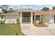 Single-story home featuring a screened entry and well-maintained landscaping at 5417 Maccaughey Dr, North Port, FL 34287