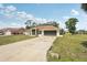 Single-story home with wide driveway and manicured front lawn in a quiet neighborhood at 5417 Maccaughey Dr, North Port, FL 34287