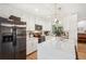 Updated kitchen featuring stainless steel appliances, white cabinets, quartz counters and decorative lighting at 5417 Maccaughey Dr, North Port, FL 34287