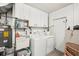 Functional laundry room with washer, dryer, storage cabinets, and utility sink, designed for efficiency at 5417 Maccaughey Dr, North Port, FL 34287