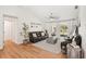 Inviting living room with laminate floors, modern ceiling fan, and sliding doors for outdoor access at 5417 Maccaughey Dr, North Port, FL 34287