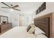 Spacious main bedroom with a ceiling fan, decorative wall art, and a view into the bathroom at 5417 Maccaughey Dr, North Port, FL 34287