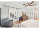 Bright main bedroom with a ceiling fan, sliding glass doors, and an accent chair at 5417 Maccaughey Dr, North Port, FL 34287