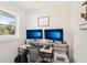 Bright home office with dual monitors, modern desk setup, and natural light; a productive workspace at 5417 Maccaughey Dr, North Port, FL 34287