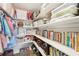 Organized walk-in pantry featuring white shelving stocked with clear containers, baskets, books, and snacks at 5417 Maccaughey Dr, North Port, FL 34287