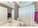 Well-lit bathroom with a shower, toilet, and single sink vanity at 5766 Stone Pointe Dr, Sarasota, FL 34233