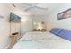 Comfortable bedroom featuring neutral walls, plush bedding, and natural light at 5766 Stone Pointe Dr, Sarasota, FL 34233