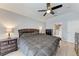 Bedroom featuring a bed, neutral walls, ceiling fan, tiled floors, and an ensuite bathroom at 5766 Stone Pointe Dr, Sarasota, FL 34233