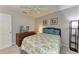 Comfortable bedroom features neutral walls, plush bedding, and natural light at 5766 Stone Pointe Dr, Sarasota, FL 34233