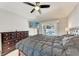 Bedroom featuring a large bed, ceiling fan, television, and a view of the pool at 5766 Stone Pointe Dr, Sarasota, FL 34233