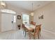 Dining room with wood table and chairs, decorative chandelier, and wood-style floors at 5766 Stone Pointe Dr, Sarasota, FL 34233