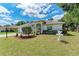 Well-kept single-story home with a manicured lawn, decorative front yard, and lovely curb appeal at 5766 Stone Pointe Dr, Sarasota, FL 34233