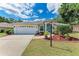 Charming single-story home featuring a well-maintained lawn, two-car garage, and beautiful landscaping at 5766 Stone Pointe Dr, Sarasota, FL 34233
