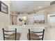 Bright kitchen with white appliances, breakfast bar, and neutral décor at 5766 Stone Pointe Dr, Sarasota, FL 34233