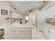 Bright kitchen with white cabinets, countertops, stainless faucet, and recessed lighting at 5766 Stone Pointe Dr, Sarasota, FL 34233