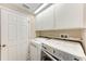 Efficient laundry room with modern washer, dryer, and storage cabinets at 5766 Stone Pointe Dr, Sarasota, FL 34233