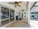 Covered patio featuring ceiling fans, tile flooring, and sliding glass doors for indoor/outdoor living at 5766 Stone Pointe Dr, Sarasota, FL 34233