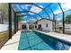 Sparkling pool inside of screened enclosure, with clear blue skies and white exterior of home at 5766 Stone Pointe Dr, Sarasota, FL 34233