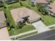 Aerial view of a beautifully landscaped single-story home with a tile roof, in a well-maintained community at 615 May Apple Way, Venice, FL 34293