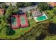 Aerial shot of tennis courts, a pool, and a clubhouse at 615 May Apple Way, Venice, FL 34293