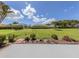 Expansive backyard with lush green lawn, mature trees, and well-maintained landscaping at 615 May Apple Way, Venice, FL 34293