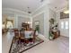 Bright dining room with a dining table, chandelier and views to other living spaces at 615 May Apple Way, Venice, FL 34293