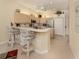 Bright eat-in kitchen with bar seating, stainless appliances and tile flooring at 615 May Apple Way, Venice, FL 34293