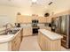 Bright kitchen featuring stainless steel appliances, tile floors, and plenty of cabinet space at 615 May Apple Way, Venice, FL 34293