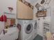 Functional laundry room with a washer, dryer, sink, and storage cabinets at 615 May Apple Way, Venice, FL 34293