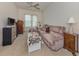 A comfortable living room with a plush sofa, side tables, and a television set is ideal for relaxation at 615 May Apple Way, Venice, FL 34293