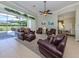 Spacious living room with large windows and comfortable leather seating at 615 May Apple Way, Venice, FL 34293
