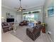 Comfortable living room with plush seating, neutral carpet, and bright natural light at 615 May Apple Way, Venice, FL 34293