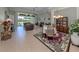 Spacious living room featuring a dining area, chandelier, tile floors and lots of natural light at 615 May Apple Way, Venice, FL 34293