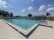 A community pool with clear blue water is surrounded by a patio area with a four-foot depth mark at 615 May Apple Way, Venice, FL 34293