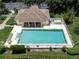 Aerial view of a community pool surrounded by lounge chairs and palm trees at 615 May Apple Way, Venice, FL 34293